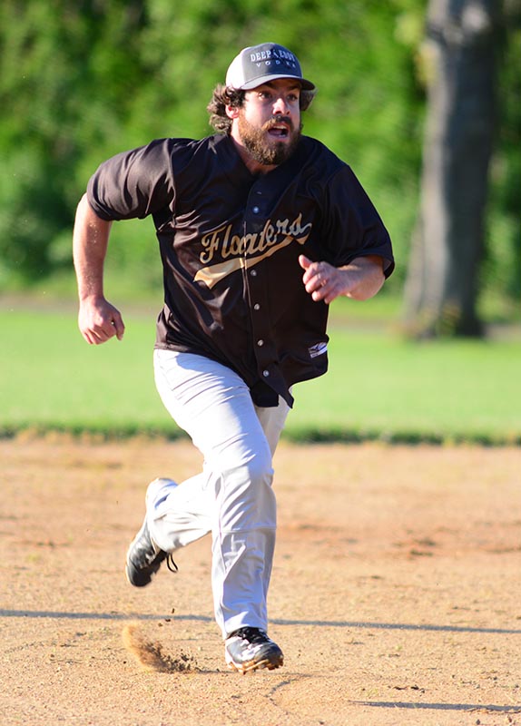 Chris Bonica hustles toward third base.
