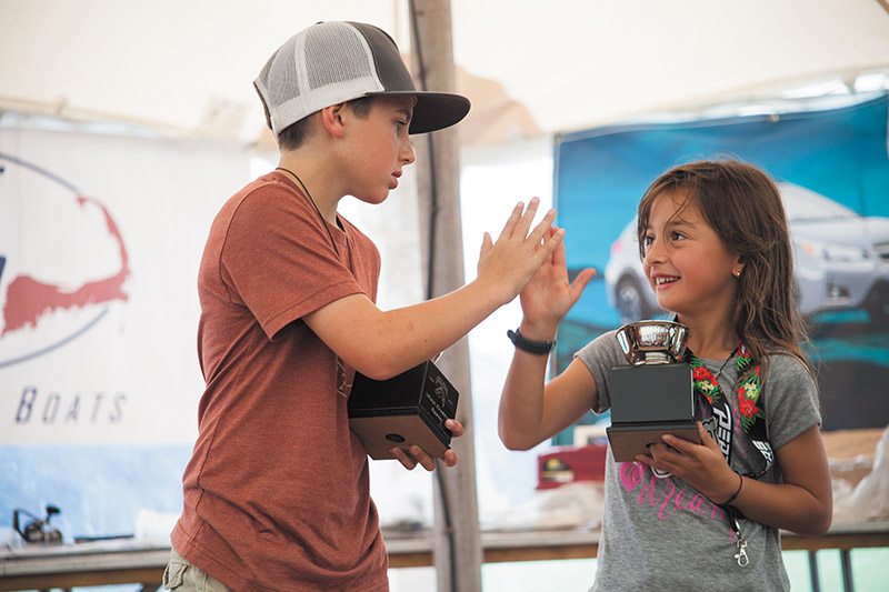 Elizabeth Thompson high fives fellow award winner Mason Warburton, left.