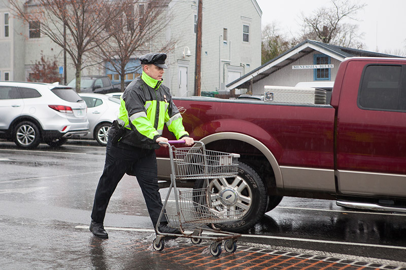 Tisbury Detective Max Sherman returns a shopping cart to keep traffic moving.