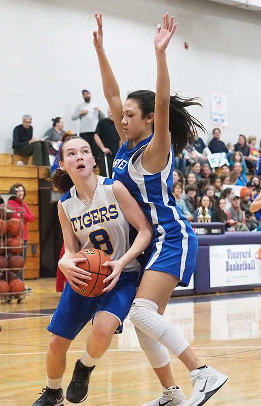 Katherine DeSorcy has her eyes on the basket with Maria Andrade guarding tight.