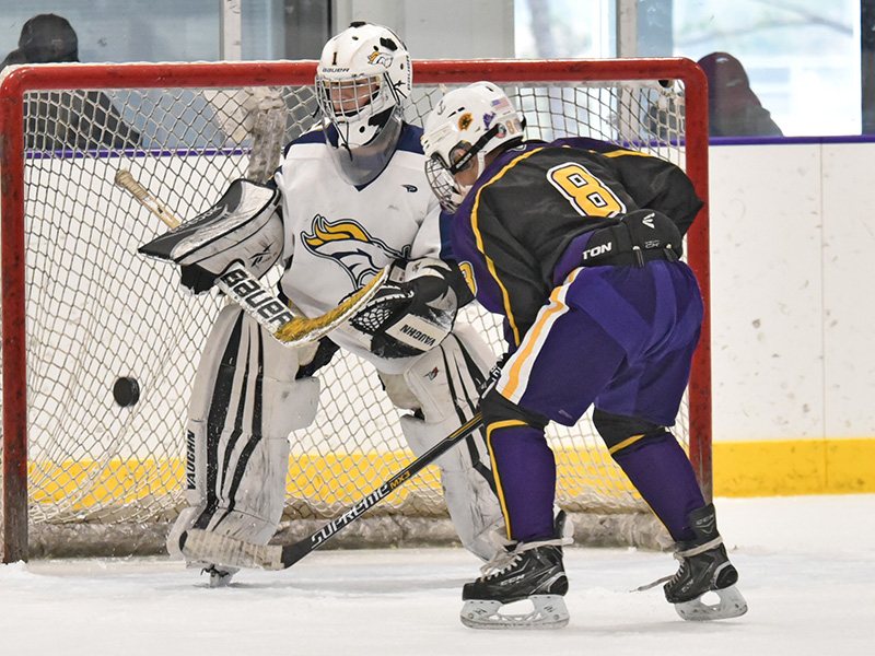 Nate Averill attacks the net to follow up on a Vineyard shot.