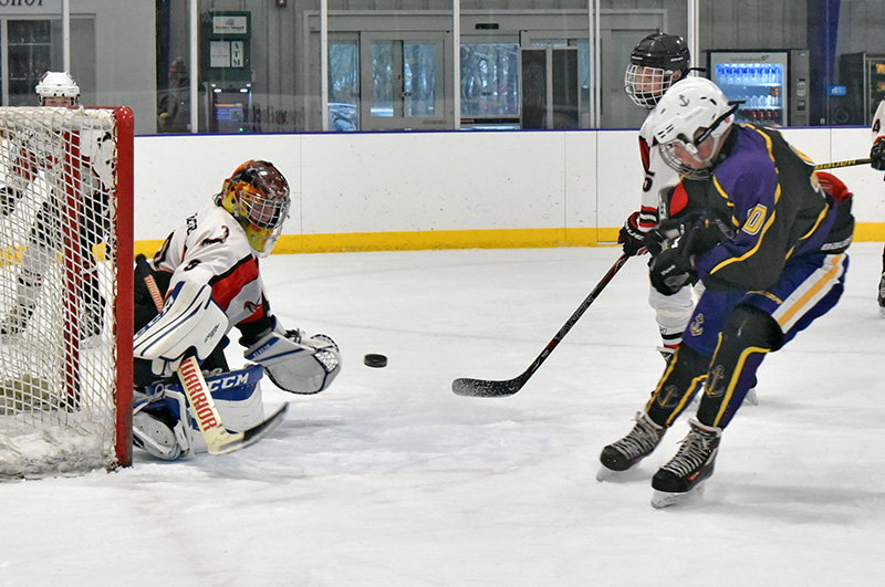 MVYH Bantam Harper Hearn fires a shot on the Lower Cape Coyotes net minder.