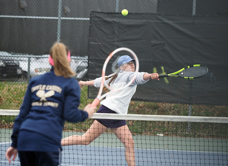 Chesca Potter hustles to make a backhand volley.
