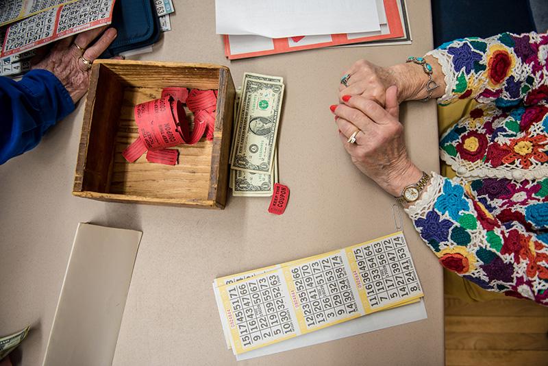 Pat Johnson, right, sells $1 blackout bingo sheets.