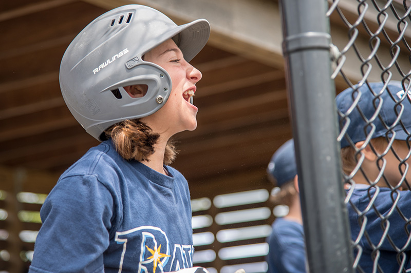 Rays player Avery Mulvey cheers on her teammate from the dugout.
