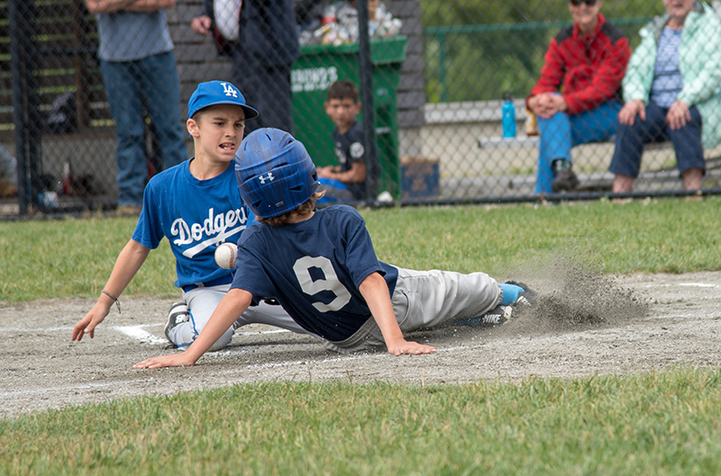 Dodgers pitcher Leo Napior, left, attempts to tag Blake Kingsley out at home.