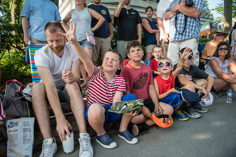 Kids line the parade route, and reach for candy.