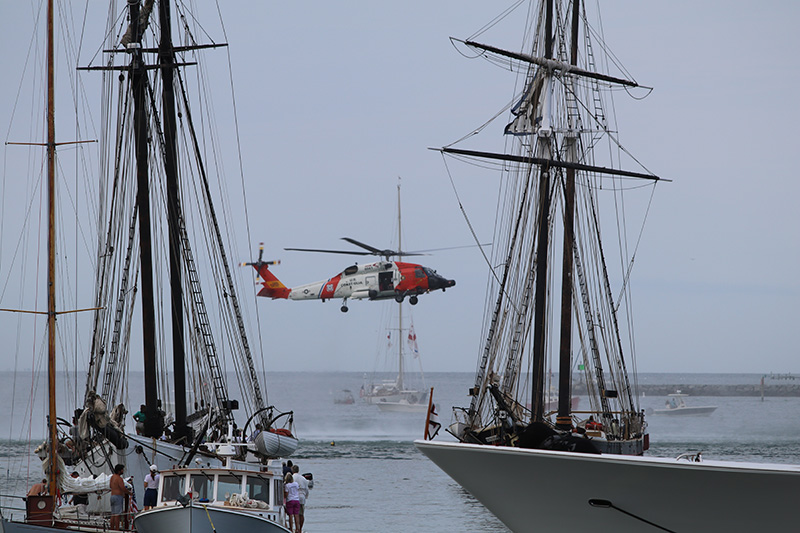 People watch the demonstration from their boats in the Vineyard Haven Harbor.