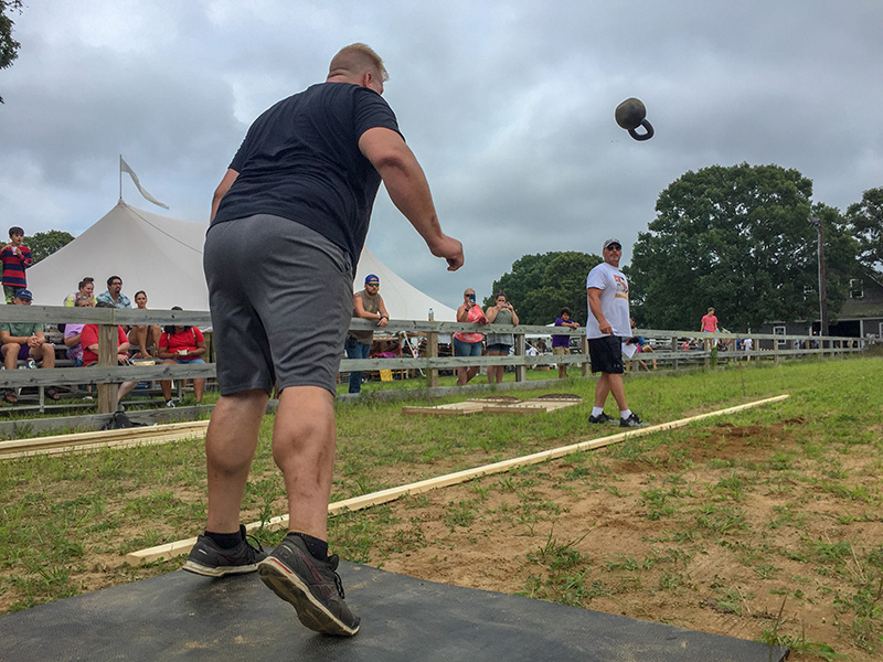 Jacob Zechner of Billerica heaves a kettlebell in the strongman competition.
