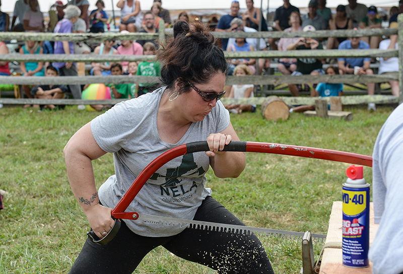 Tara Reed races to saw off a piece of wood in the Women’s Horizontal Chop.