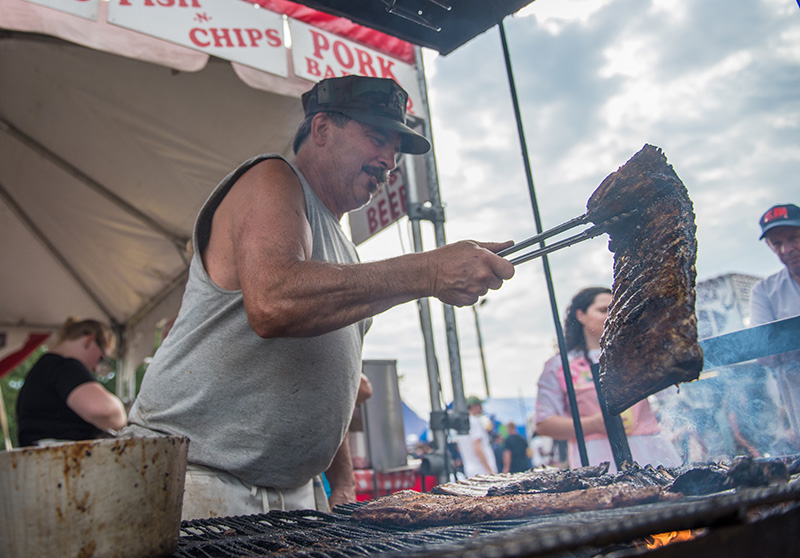 “Buffalo Bill” White cooks ribs at the fair.