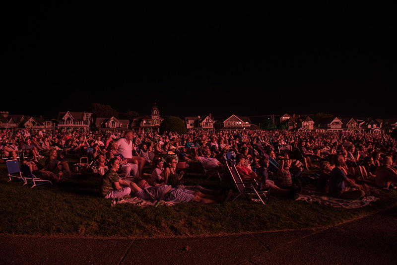 The crowd illuminated by the firework’s glow.