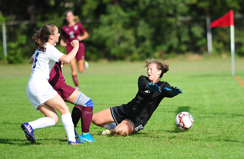Ruby Reimann slides to make a save vs. Bishop Stang in 2017.