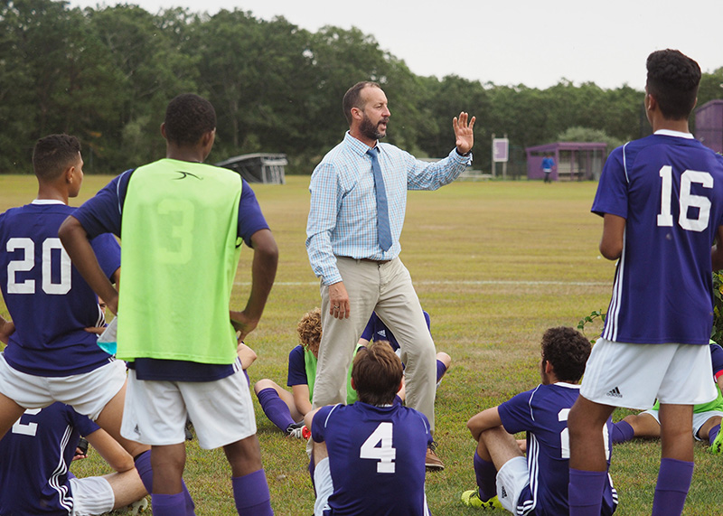Vineyard coach Esteban Aranzabe addresses his team during the halftime break.