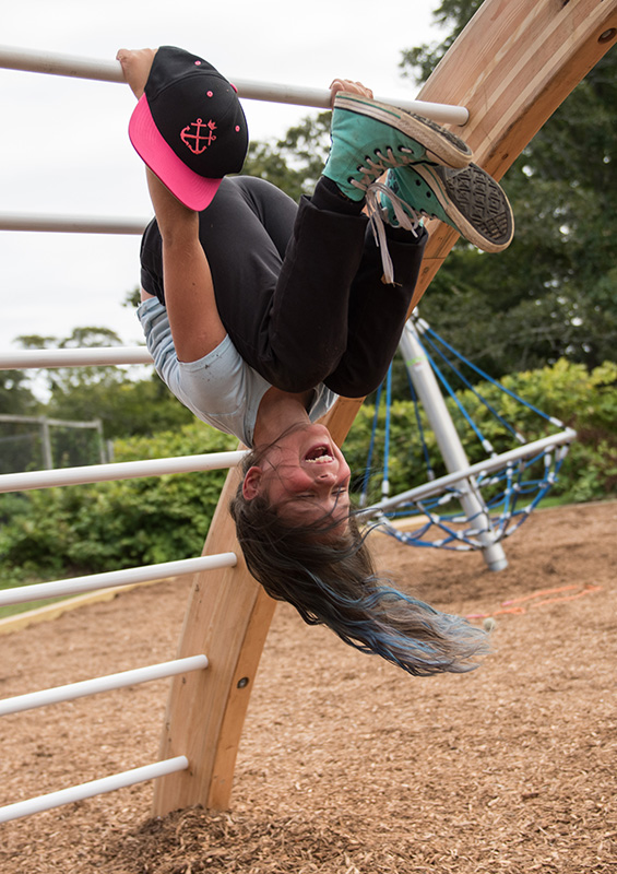 Bella Arters, fourth grade, hangs off the arched monkey bars.