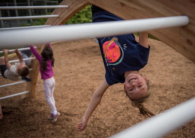 Wren Robertson, third grade, hangs off the monkey bars during recess.