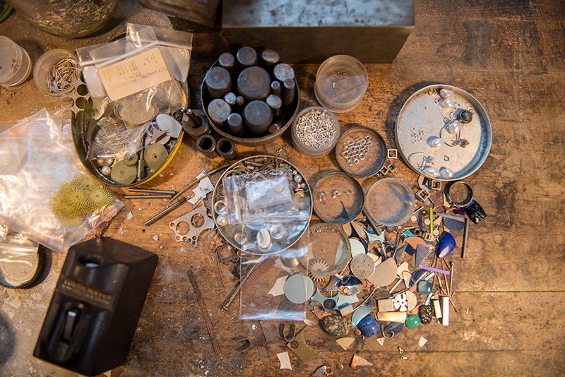 Kenneth Pillsworth’s work table, covered with metal and jewerly pieces.