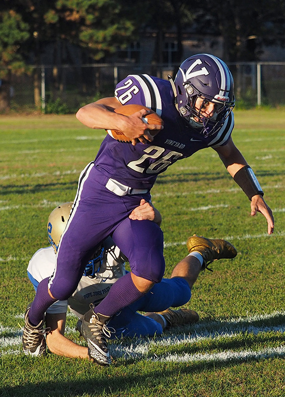 Mike Satkevich tries to contain Vineyard runner Tristan Scheller.