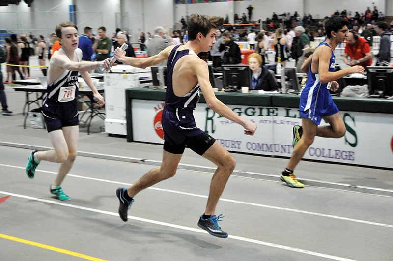 Jonathan Norton hands the baton to Zach Utz in the 4 x 800 meter relay.