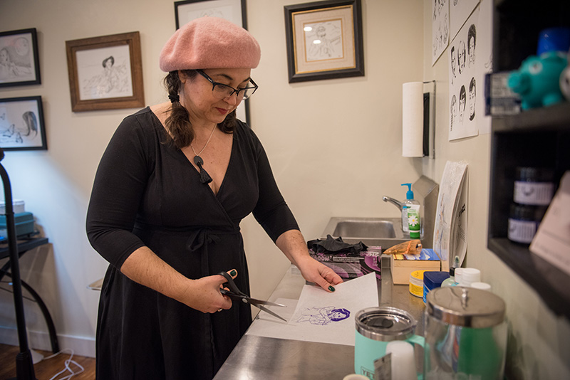 Tattoo artist Molly Kiely prepares the Nancy Pelosi clap stencil she designed.