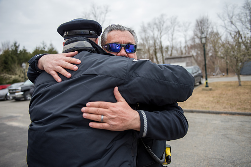 Sergeant Thomas Smith hugs an officer while saying his goodbyes.