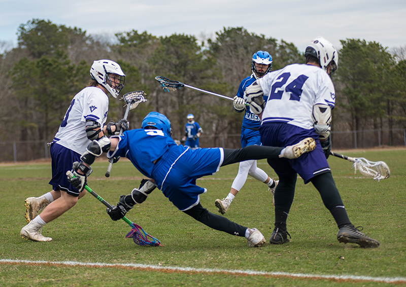 A Falmouth Academy player falls amid a frenzy for the ball.
