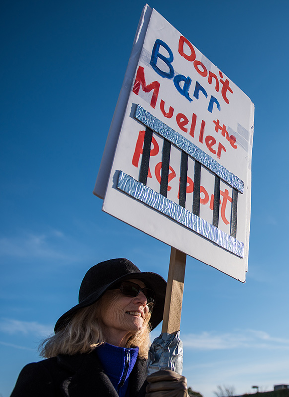 Margaret Emerson stands with her clever handmade sign.