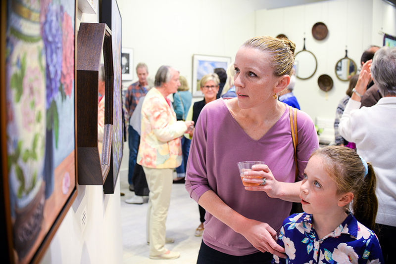 Valerie Lavigne and daughter Evelyn, 7, try to make sense of a piece together.
