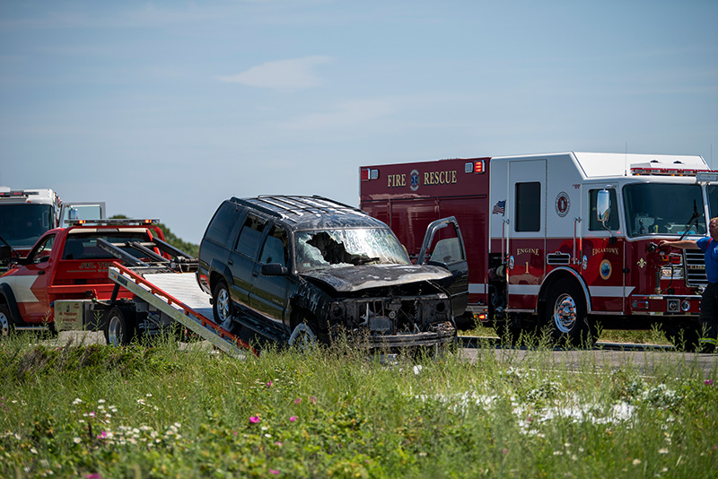 The SUV is towed from the scene.