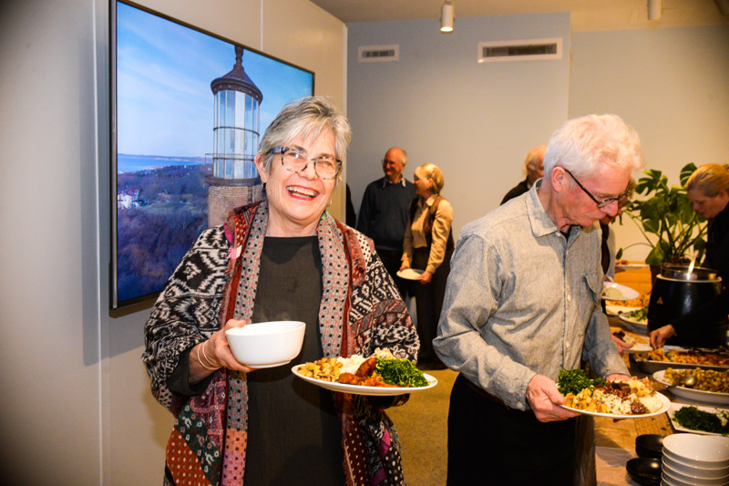 Lynne patiently waits for husband Allen Whiting to complete his dinner plate.