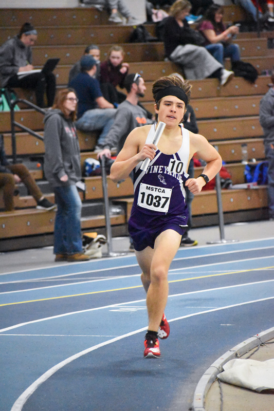 Vito Aiello runs the relay event.