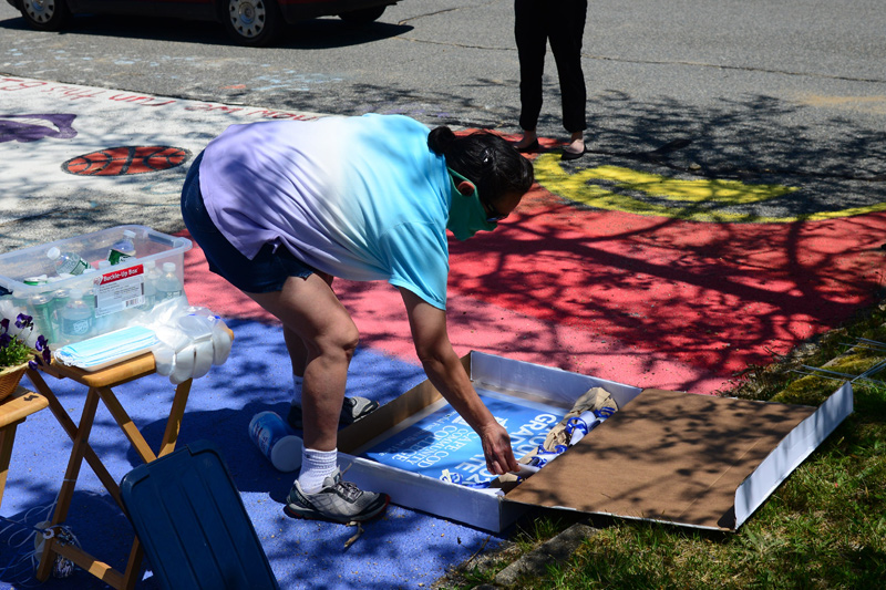 Yolanda Tucker takes a yard sign recognizing the 2020 4Cs graduates.