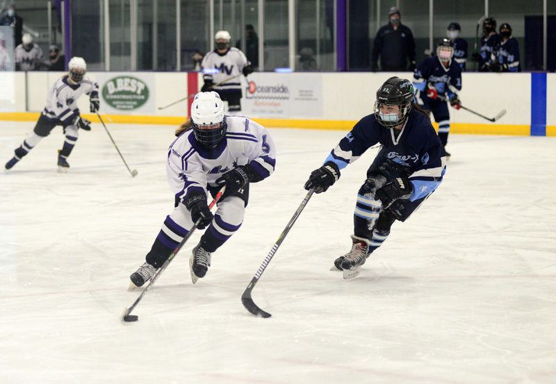 Marin Gillis carries the puck against Sandwich’s Megan Barrett.