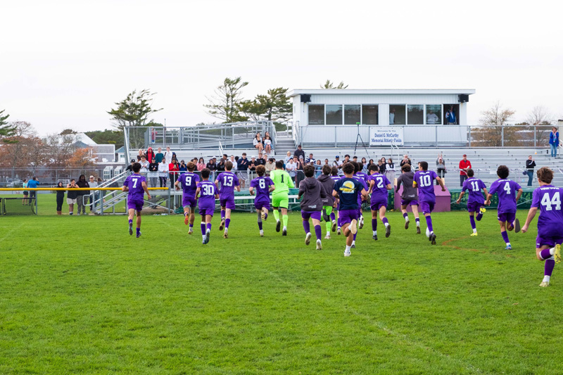 Boys-Varsity-Soccer_team-running-to-fans.jpg