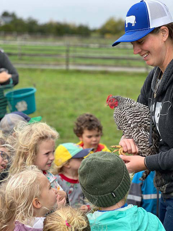 Julie holding a chicken.