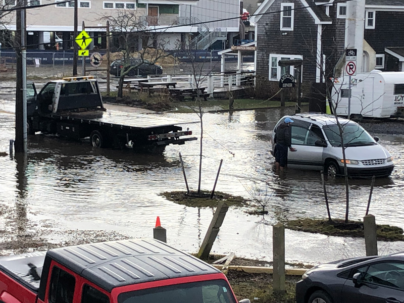 Another vehicle gets towed after stalling on a flooded Beach Road