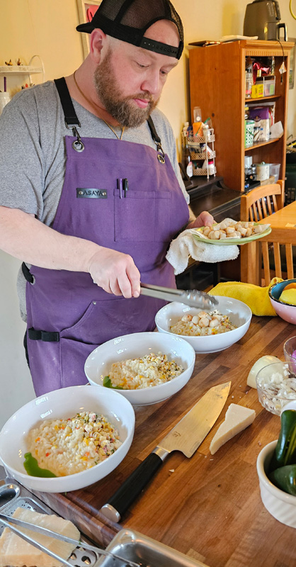 Kelleher adding scallops to risotto.