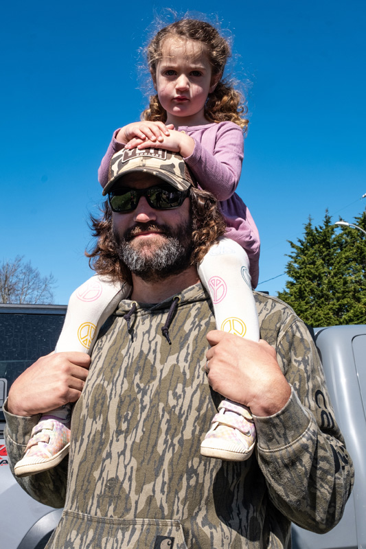 Aaron Brown paraded with his daughter Juniper on his shoulders.