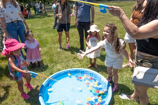 Children and their families enjoyed fishing for toys in the kiddie pools.
