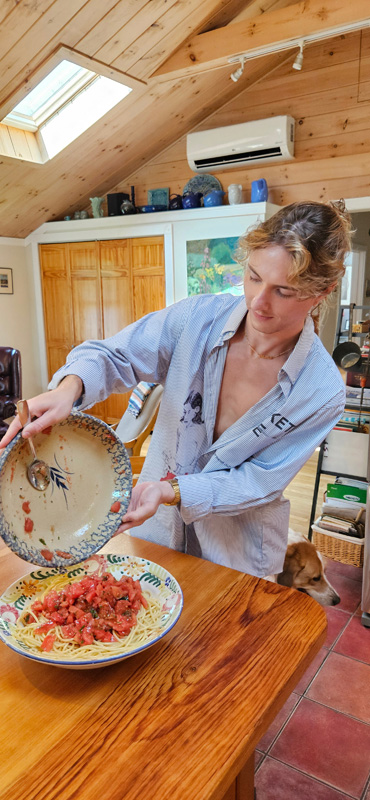 Sam Oslyn pouring tomatoes into bowl