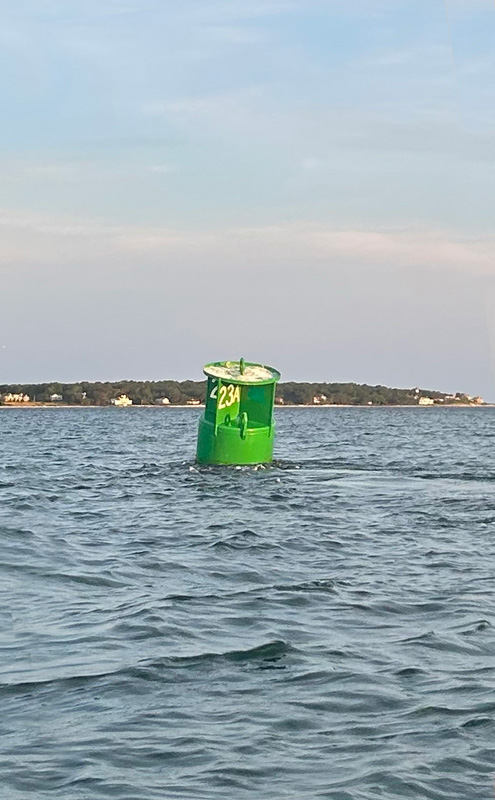 The current pulling on the green buoy.