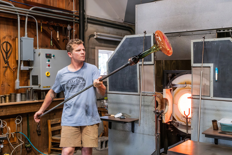 Wil Sideman removed a decanter from the reheating oven to do more work on it.