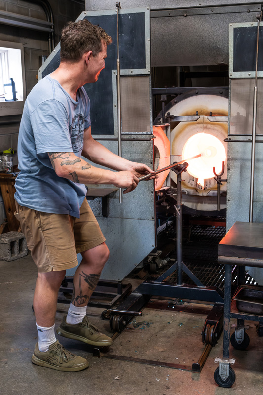 The decanter is heated in the oven many times to mold it into its final shape.