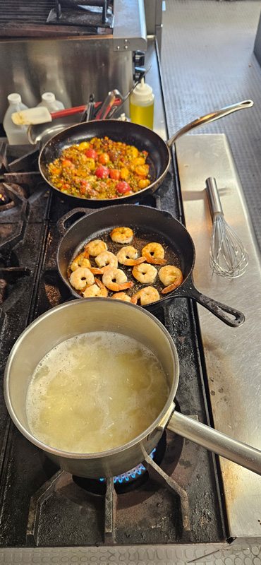 Grits, veggies and spices, and shrimp cooking