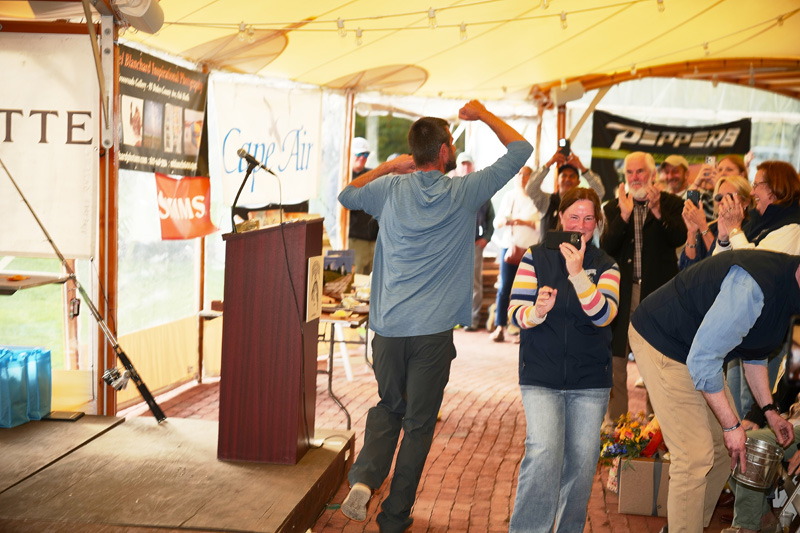 Sam Bell running to cheers from anglers after winning the grand prize.