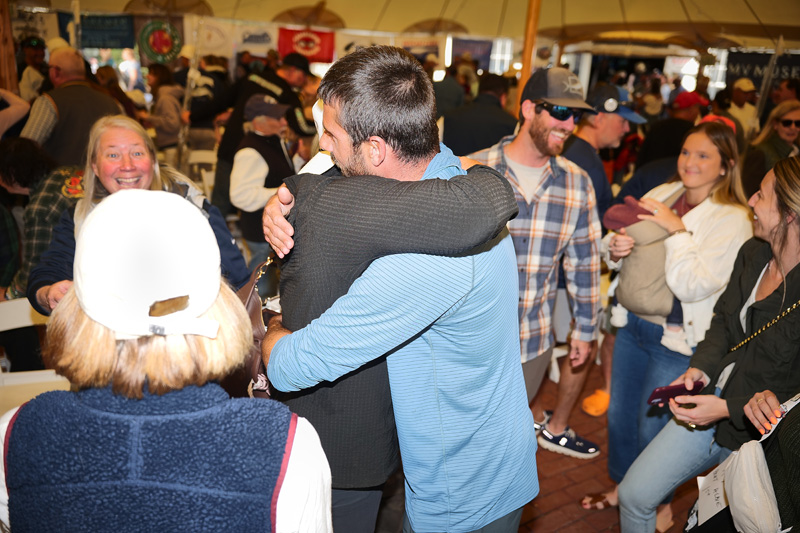 Sam Bell hugging friends after winning derby grand prize.