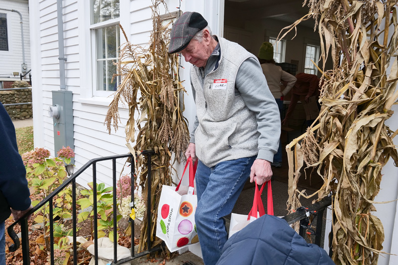 Volunteers made their way outside with various foods for delivery.