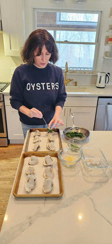 Julia Blanter placing spinach on the oysters.
