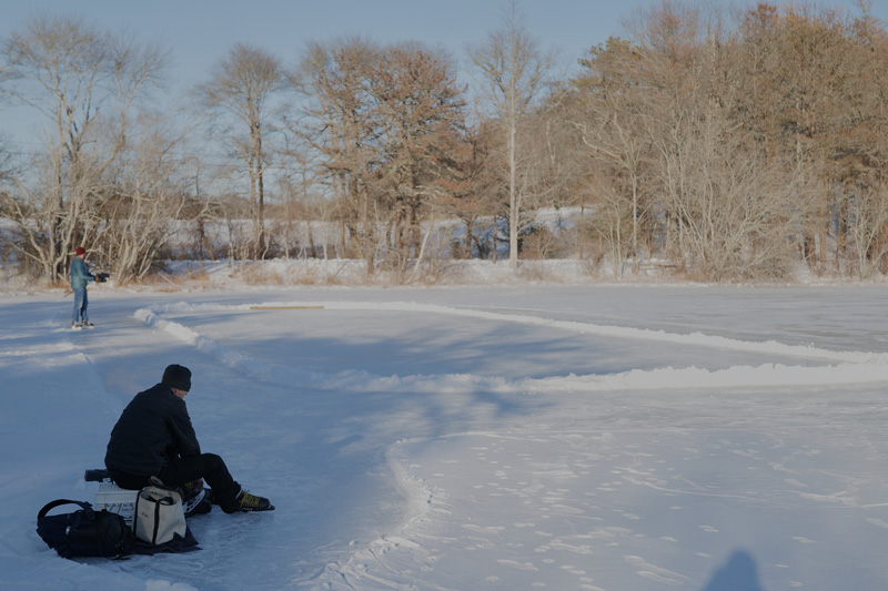 Brian Donnelly laces up his skates on Duarte’s pond.