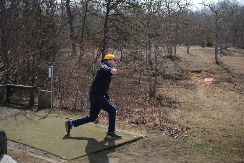 Jake Gifford, owner of Lazy Frog in Oak Bluffs, throws his disc.